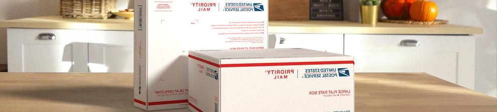 Two Priority Mail International® boxes sitting on a table.